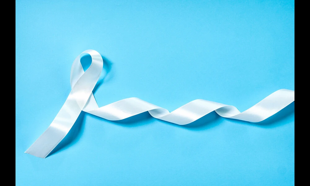 White ribbon as symbol of woman violence or lung cancer on blue background | Marco Verch on Flickr